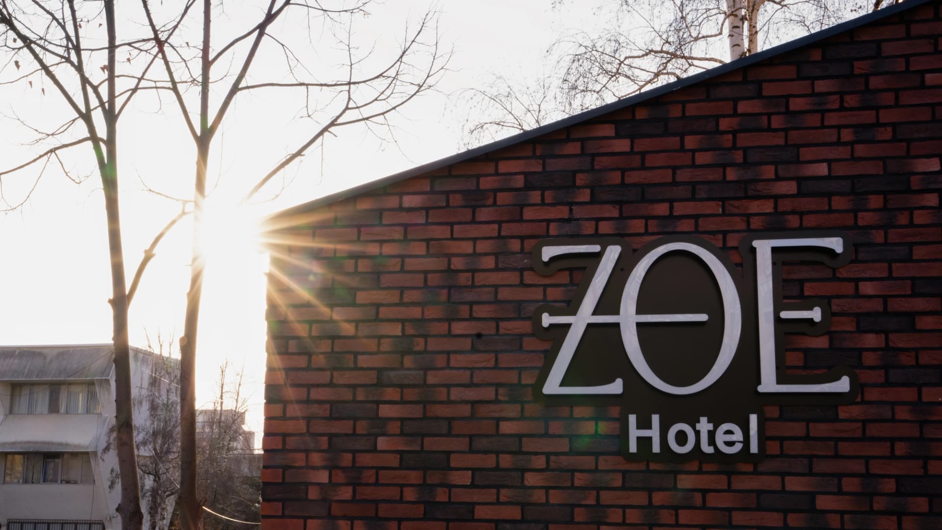 ZOE Hotel exterior sign at sunset